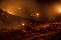 <p>A hillside glows with embers as the Thomas fire burns through Los Padres National Forest near Ojai, Calif., on Friday, Dec. 8, 2017. (Photo: Noah Berger/AP) </p>