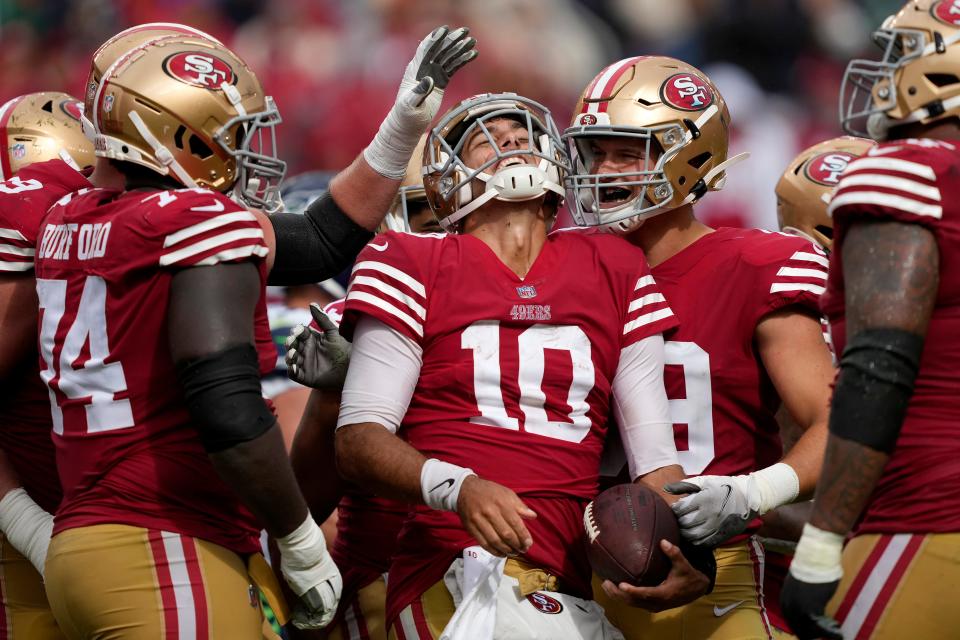 San Francisco 49ers quarterback Jimmy Garoppolo (10) celebrates with teammates during the second half of an NFL football game against the Seattle Seahawks in Santa Clara, Calif., Sunday, Sept. 18, 2022. (AP Photo/Tony Avelar)