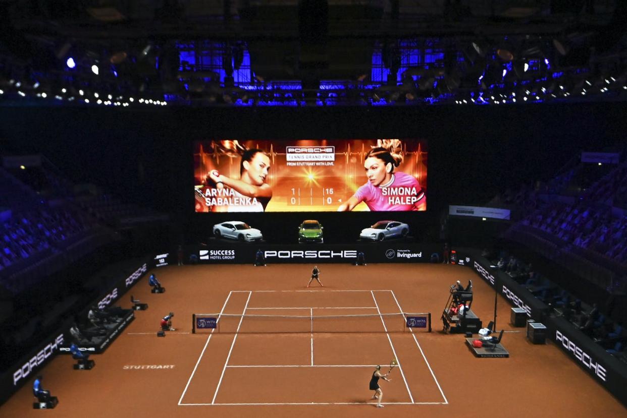 <span class="caption">Aryna Sabalenka from Belarus returns the ball to Simona Halep of Romania during their semifinal tennis match of the women's singles WTA Tour Porsche Grand Prix in Stuttgart, Germany in April 2021.</span> <span class="attribution"><span class="source">(Marijan Murat/Pool via AP)</span></span>