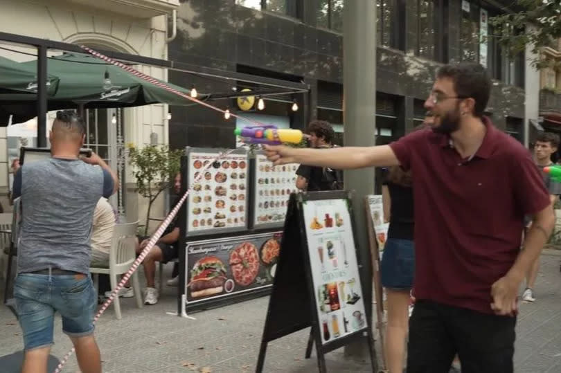 Water-pistol brandishing anti-tourism protesters spray people in bars in Barcelona