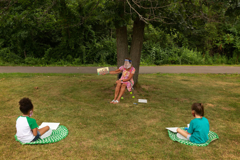 Teacher Judy David reads to first-graders. When possible, some lessons are held outside | Gillian Laub for TIME