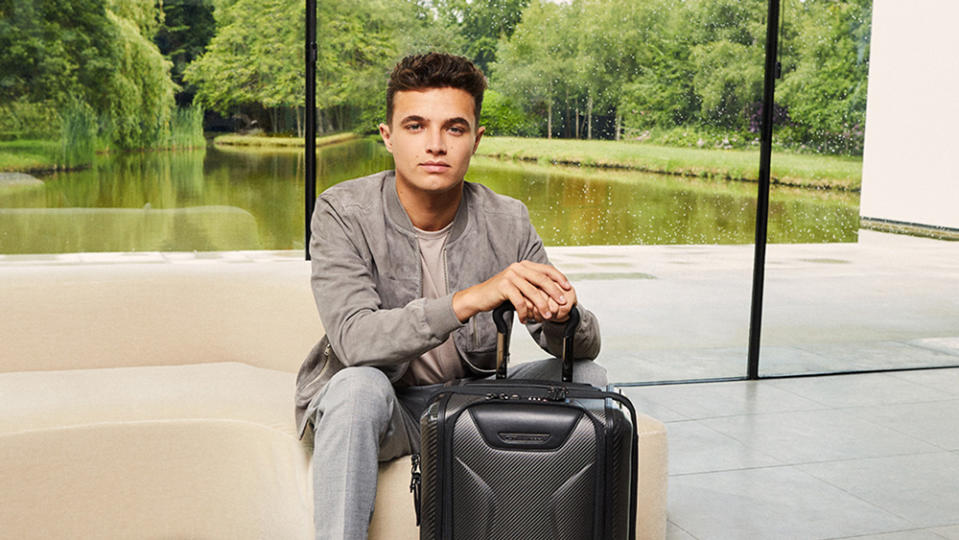 Formula 1 racer Lando Norris seen with one of the luggage pieces from Tumi's McLaren Collection.