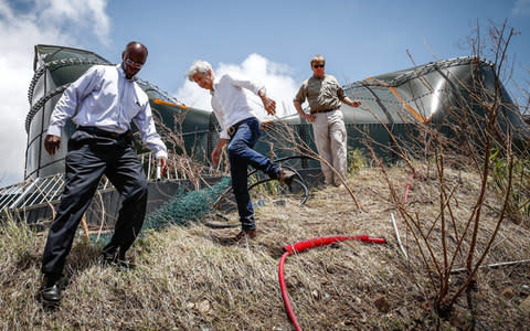 Dutch king Willem-Alexander (R) and Minister of Internal Affairs Ronald Plasterk (C) visit a damaged watertank on September 11, 2017, at Filipsburg on the Dutch Caribbean island of Saint Martin - Credit: VINCENT JANNINK/AFP