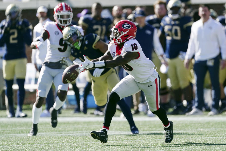 Georgia's Kearis Jackson (10) mishandles a punt before returning it in the first half of an NCAA college football game against the Georgia Tech Saturday, Nov. 27, 2021, in Atlanta. (AP Photo/John Bazemore)