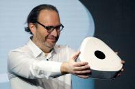 FILE PHOTO: Xavier Niel, founder of French broadband Internet provider Iliad, shows off the new set-top box, the Freebox Delta, in Paris