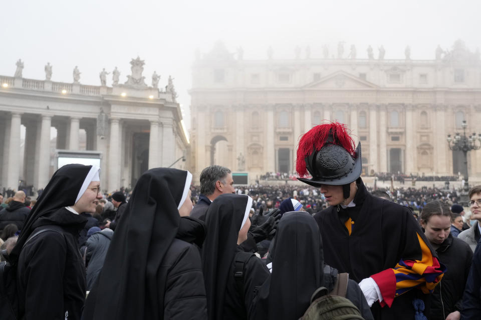 Faithful arrive into St. Peter's Square at the Vatican, ahead of the funeral mass for late Pope Emeritus Benedict XVI, Thursday, Jan. 5, 2023. Benedict died at 95 on Dec. 31 in the monastery on the Vatican grounds where he had spent nearly all of his decade in retirement, his days mainly devoted to prayer and reflection. (AP Photo/Gregorio Borgia)