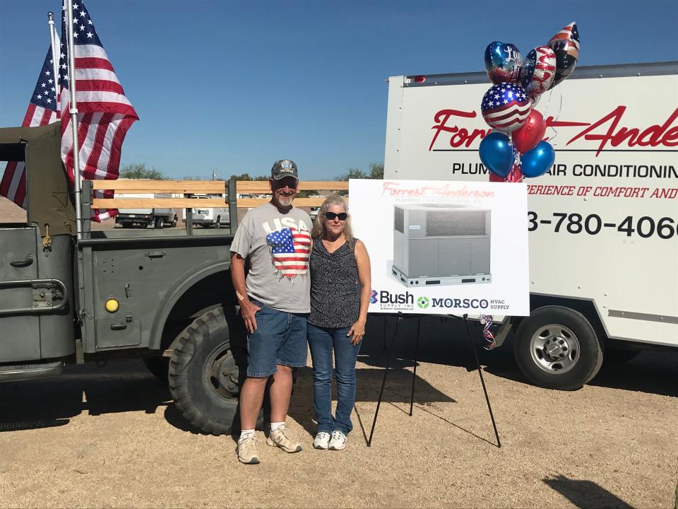 Dan and Brenda Dennison  win a free A/C unit from Forrest Anderson.
