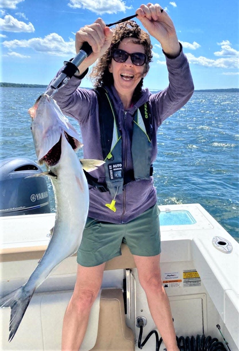 Amy Mosses with a feisty bluefish. Regulations are the same in Massachusetts and Rhode Island for bluefish — three fish for private anglers and five for charter boats.