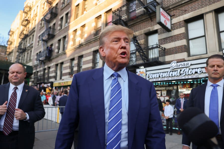 Former president Donald Trump, talks to members of the media while visiting a bodega, Tuesday, April 16, 2024, who’s owner was attacked last year in New York. Fresh from a Manhattan courtroom, Donald Trump visited a New York bodega where a man was stabbed to death, a stark pivot for the former president as he juggles being a criminal defendant and the Republican challenger intent on blaming President Joe Biden for crime. Alba’s attorney, Rich Cardinale, second from left, and Fransisco Marte, president of the Bodega Association, looked on. (AP Photo/Yuki Iwamura)