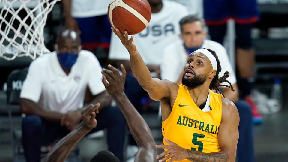 Patty Mills is seen here scoring a basket against Team USA. 