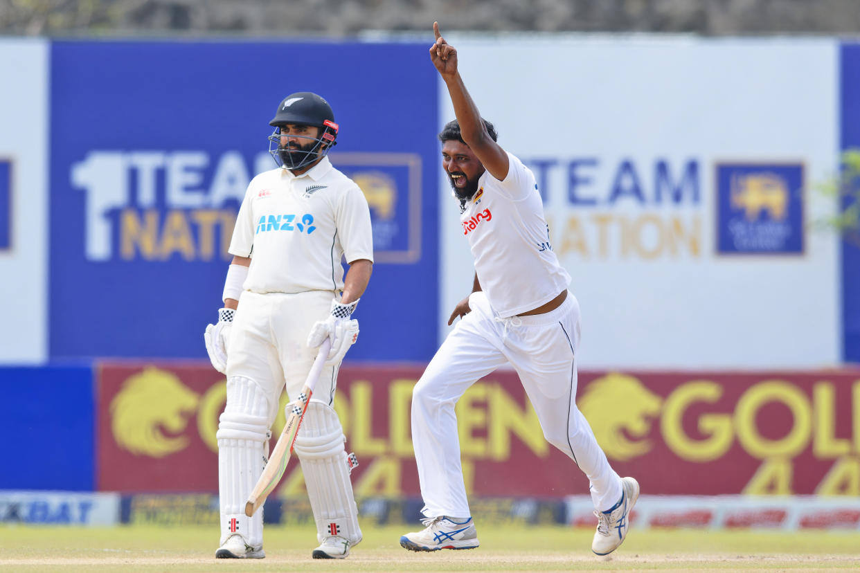 Sri Lanka's Prabath Jayasuriya, right, celebrates the wicket of New Zealand's Rachin Ravindra on the fifth and final day of the first cricket test match between New Zealand and Sri Lanka in Galle, Sri Lanka, Monday, Sept. 23, 2024. (AP Photo/Viraj Kothalawala)