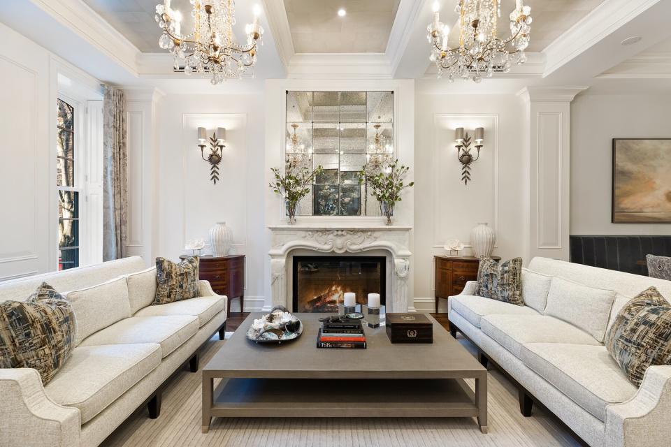 Inspirato's Breakfast at Tiffany's Brownstone's living room with fireplace and chandeliers