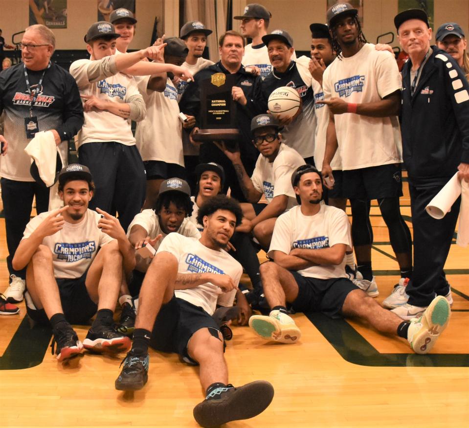 Brookdale Community College's players and coaches pose with the 2023 NJCAA Division III men's basketball championship trophy at Herkimer College following the tournament championship game. The Jersey Blues, rankd No. 1 in the nation, are back for the 2024 tournament with an at-larg bid after suffering their first loss in the Region XIX championship game.