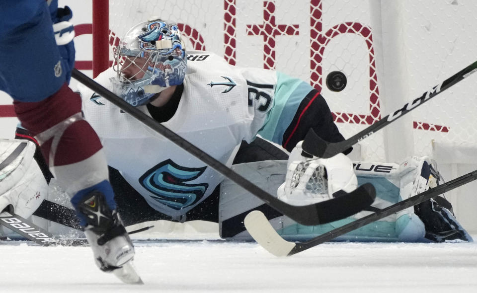 Seattle Kraken goaltender Philipp Grubauer deflects a shot during the second period of the team's NHL hockey game against the Colorado Avalanche on Friday, Oct. 21, 2022, in Denver. (AP Photo/David Zalubowski)