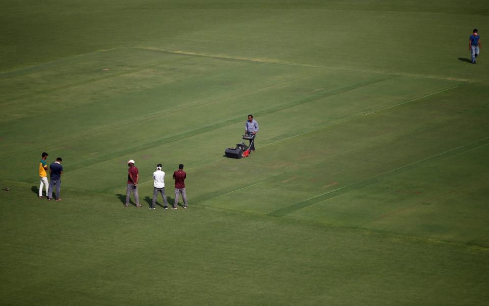 Groundsmen prepare a pitch at Sardar Patel Gujarat Stadium, where India and England are scheduled to play their third test match, in Ahmedabad - REUTERS/Amit Dave