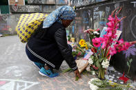 <p>A Muslim woman, who preferred not to giver her name, prays at a makeshift memorial for two men who were killed on a commuter train while trying to stop another man from harassing two young women who appeared to be Muslim, in Portland, Ore., May 29, 2017. (Terray Sylvester/Reuters) </p>