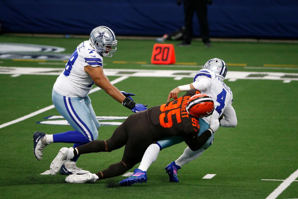 Browns defensive end Myles Garrett sacks Cowboys quarterback Dak Prescott after getting around Terence Steele (left) in the first half in Arlington, Texas, Sunday, Oct. 4, 2020.