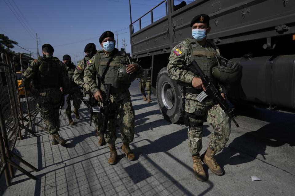 Security forces arrive to Litoral Penitentiary after deadly fights inside the jail in Guayaquil, Ecuador, Thursday, July 22, 2021. Rival gangs of inmates fought in two prisons in Ecuador, killing at least 18 people and injuring dozens, authorities said Thursday. (AP Photo/Dolores Ochoa)