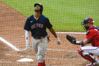 Boston Red Sox Xander Bogaerts looks skyward after hitting a home run to center field as Atlanta Braves catcher Tyler Flowers waits for the next batter during the fifth inning of a baseball game Sunday, Sept. 27, 2020, in Atlanta. (AP Photo/John Amis)