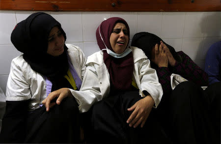 Colleagues of Palestinian nurse Razan Al-Najar, who was killed during a protest at the Israel-Gaza border, react at a hospital in the southern Gaza Strip June 1, 2018. REUTERS/Ibraheem Abu Mustafa