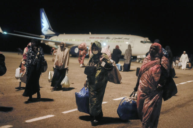 Sudanese, who had been stranded in Jeddah, Saudi Arabia, arrive at Port Sudan airport, Thursday, May 11, 2023. The conflict between the country's military and a rival paramilitary group has killed hundreds and displaced hundreds of thousands since it broke out in mid-April, creating a humanitarian crisis inside the country and at its borders. (AP Photo/Amr Nabil)
