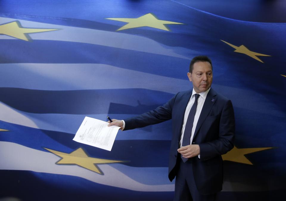 Greece's Finance Minister Yannis Stournaras arrives for a news conference with European Union's Vice President and Competition Commissioner Joaquin Almunia in Athens on Thursday, April 10, 2014. Buoyant Greek officials said the government had received strong interest for its first bond issue in four years, with Thursday's auction of five-year debt being about eight times oversubscribed — a sign of growing market confidence. "Greece has succeeded — and this is recognized by our most critical friends and partners — in achieving an exit from the crisis, or is very close to an exit from the crisis," Stournaras said on Thursday. (AP Photo/Thanassis Stavrakis)