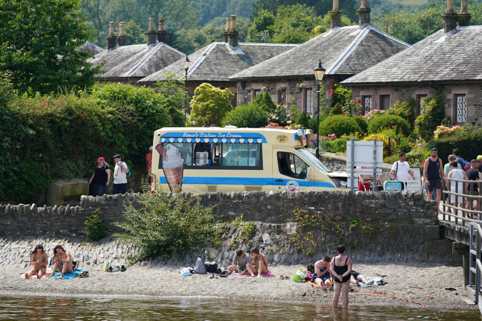 An ice cream van parked on the banks of Loch Lomond, in the village of Luss in Argyll and Bute, Scotland, Tuesday, July 19, 2022. Britain shattered its record for highest temperature ever registered amid a heat wave that has seized swaths of Europe. The national weather forecaster predicted it would get hotter still Tuesday in a country ill prepared for such extremes. (Andrew Milligan/PA via AP)