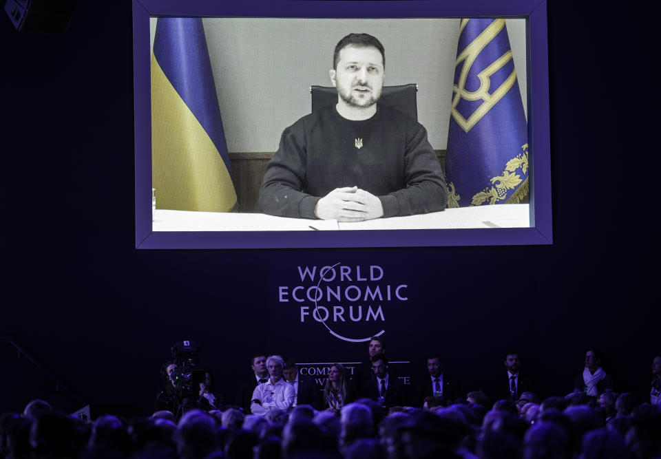 President Volodymyr Zelenskyy of Ukraine talks from a video screen to participants at the World Economic Forum in Davos, Switzerland on Wednesday, Jan. 18, 2023. The annual meeting of the World Economic Forum is taking place in Davos from Jan. 16 until Jan. 20, 2023. (AP Photo/Markus Schreiber)