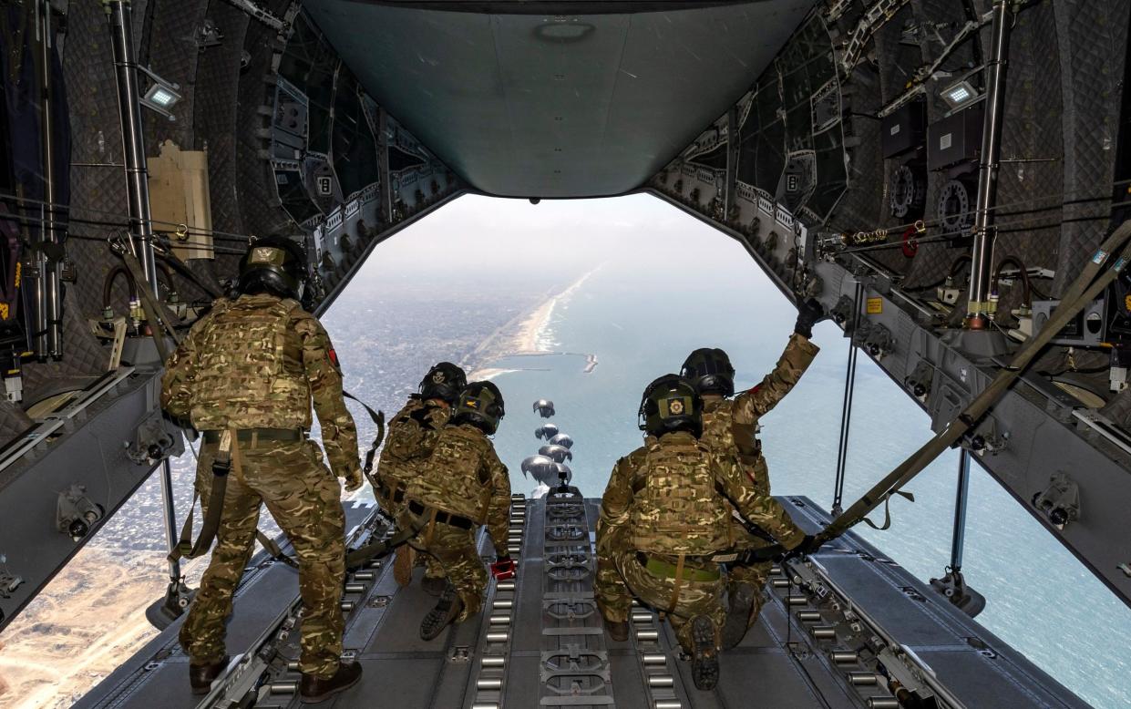 British army troop parachute aid into Gaza from an RAF jet