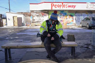 Madi Ramirez-Tentinger, a lead organizer for activism, waits to be interviewed on Feb. 24, 2021, at George Floyd Square in Minneapolis. Ten months after police officers brushed off George Floyd's moans for help on the street outside a south Minneapolis grocery, the square remains a makeshift memorial for Floyd who died at the hand of police making an arrest. The trial of former Minneapolis police officer Derek Chauvin, one of the four officers, will begin with jury selection on March 8. (AP Photo/Jim Mone)