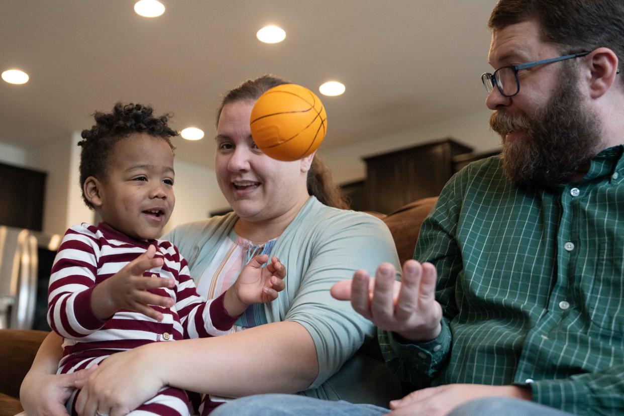 Brittney, Chris, and Samuel, 21 months, Tyler play with a ball, one of Samuel’s favorite toys, on Friday, March 1, 2024.