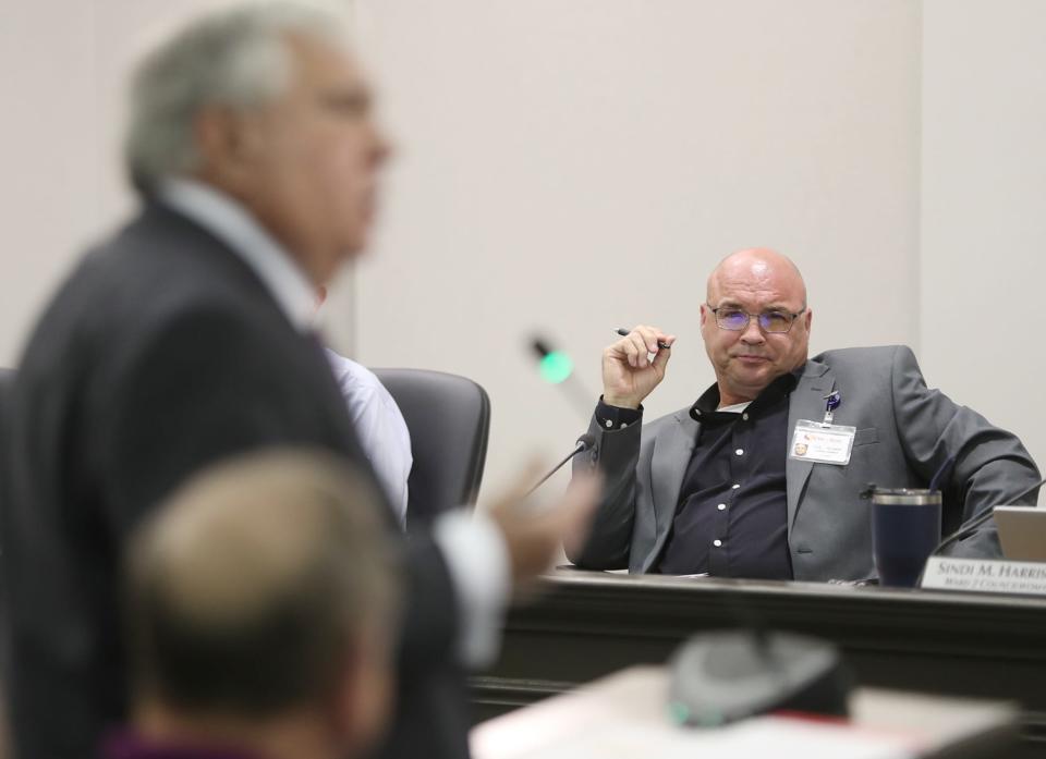 Stow City Council Member Cyle Feldman listens to attorney Alfred Schrader discuss the Miller's Landing subdivision during a Thursday council meeting.