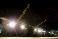 In this photo released by the Military News Agency, tanks prepare for the annual Han Kuang live-fire drills in Hualian, eastern Taiwan in the early hours of Tuesday, Sept. 14, 2021. (Military News Agency via AP)