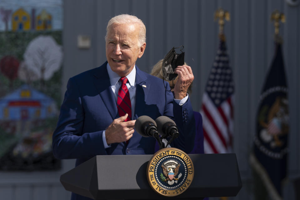 President Joe Biden, takes off his mask as he speaks to school staff during a visit at Brookland Middle School in northeast Washington, Friday, Sept. 10, 2021. Biden has encouraged every school district to promote vaccines, including with on-site clinics, to protect students as they return to school amid a resurgence of the coronavirus. (AP Photo/Manuel Balce Ceneta)