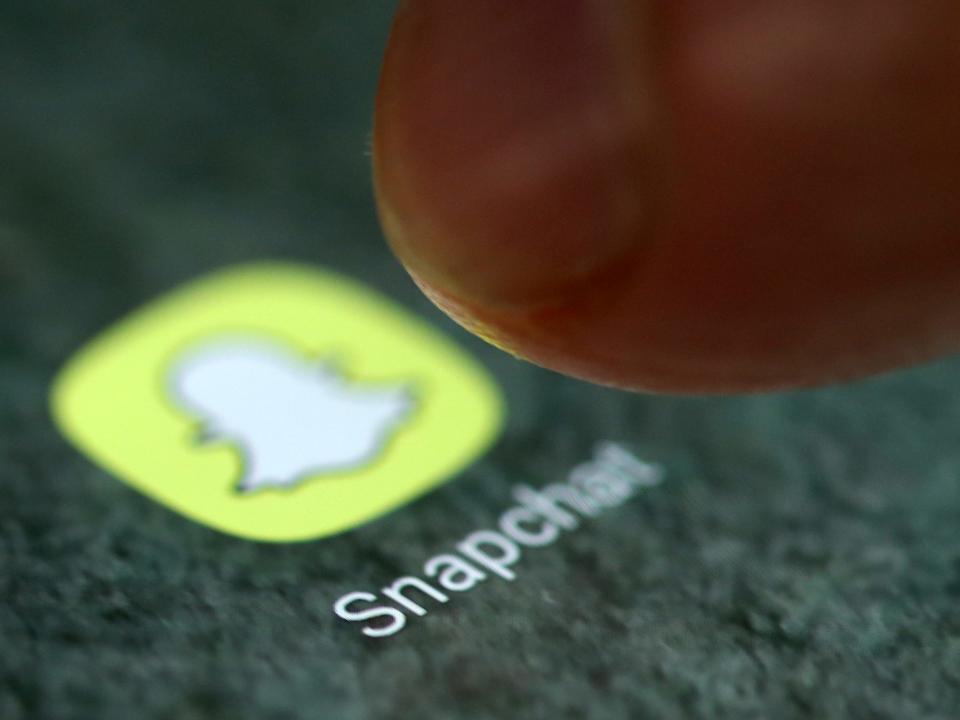 FILE PHOTO: The Snapchat app logo is seen on a smartphone in this picture illustration taken September 15, 2017. REUTERS/Dado Ruvic/Illustration