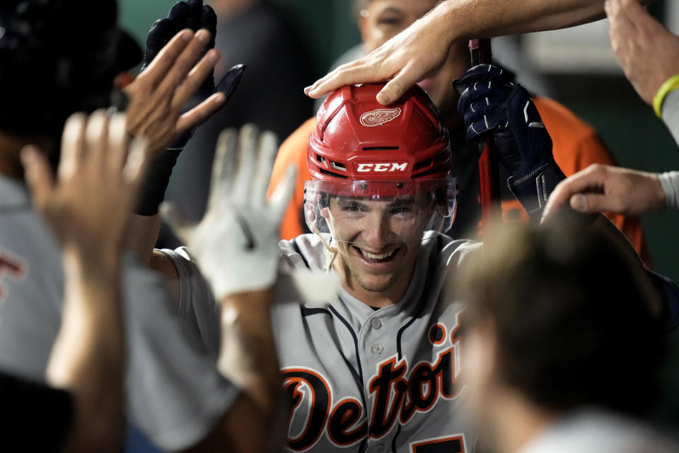 Detroit Tigers Zack Short wears a Red Wings hockey helmet as celebrates in the dugout after hitting a three-run home run against the Kansas City Royals, Wednesday, May 24, 2023, in Kansas City, Mo. About half the clubs in MLB are using some kind of prop or ritual to celebrate a big hit or a big play in ways that often go viral. (AP Photo/Charlie Riedel)