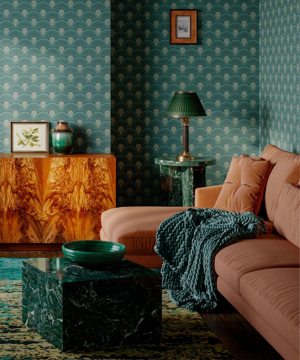 A green living room with a pink couch, green marble table, and wooden console table