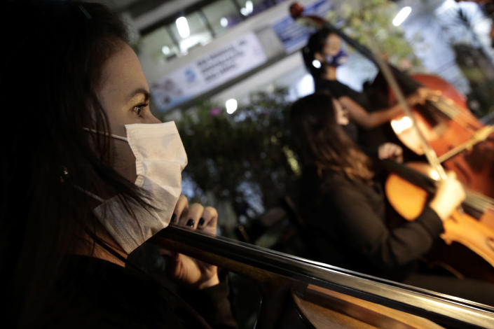 The Brasilia Philharmonic Orchestra performs at the HRAN Reference Hospital for COVID-19 in Brasilia, Brazil, Thursday, May 20, 2021. The concert is in honor of health professionals who work on the front lines to combat the pandemic. (AP Photo/Eraldo Peres)