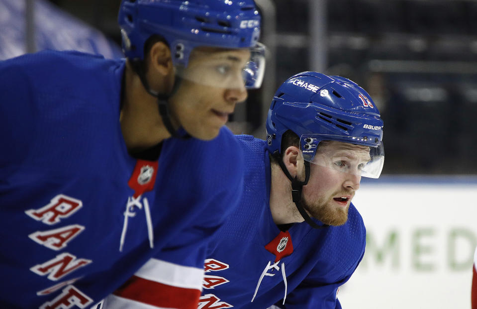 New York Rangers' K'Andre Miller, left, and Alexis Lafreniere wait for a faceoff against the New York Islanders during an NHL hockey game Thursday, Jan. 14, 2021, in New York. (Bruce Bennett/Pool Photo via AP)