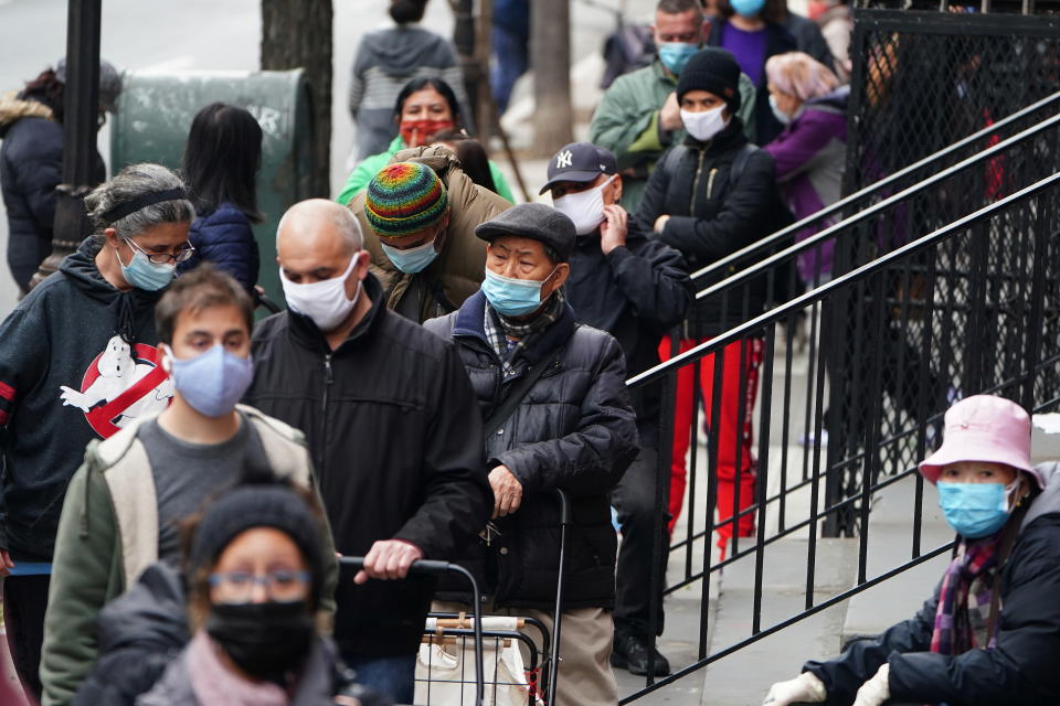 People wait in line at the St. Clements Food Pantry for food during the coronavirus disease (COVID-19) pandemic in the Manhattan borough of New York City, New York, U.S., December 11, 2020. REUTERS/Carlo Allegri