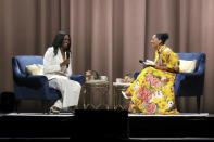 Former first lady Michelle Obama, left, and Tracee Ellis Ross speak at the "Becoming: An Intimate Conversation with Michelle Obama" event at the Forum on Thursday, Nov. 15, 2018, in Inglewood, Calif. (Photo by Willy Sanjuan/Invision/AP)