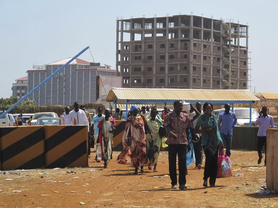 Displaced Sudanese civilians arrive to the United Nations Mission in the Republic of South Sudan (UNMISS) compound on the outskirts of the capital Juba in South Sudan, in this December 18, 2013 handout photograph from the UNMISS. Fighting between South Sudanese soldiers spread to the flashpoint town of Bor on Wednesday, raising fears of a broader civil conflict in the two-year-old nation. An official in Bor, north of Juba, said soldiers attacked each other at two military barracks and one journalist said troops loyal to Vice President Riek Machar now controlled them, suggesting violence was increasingly running along ethnic lines. REUTERS/UNMISS/Handout via Reuters (SOUTH SUDAN - Tags: CIVIL UNREST POLITICS SOCIETY CONFLICT) ATTENTION EDITORS - THIS IMAGE WAS PROVIDED BY A THIRD PARTY. FOR EDITORIAL USE ONLY. NOT FOR SALE FOR MARKETING OR ADVERTISING CAMPAIGNS. THIS PICTURE IS DISTRIBUTED EXACTLY AS RECEIVED BY REUTERS, AS A SERVICE TO CLIENTS. NO SALES. NO ARCHIVES