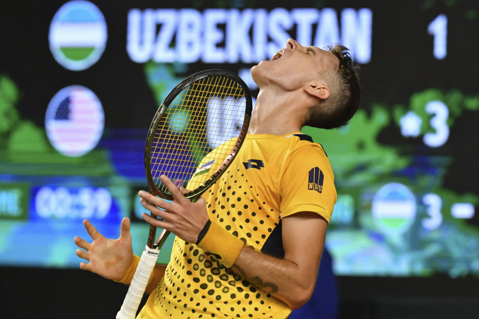 Sergey Fomin of Uzbekistan reacts during a singles Davis Cup qualifier tennis match between Uzbekistan and the USA against Mackenzie McDonald of the USA in Tashkent, Uzbekistan, Friday, Feb. 3, 2023. (AP Photo)