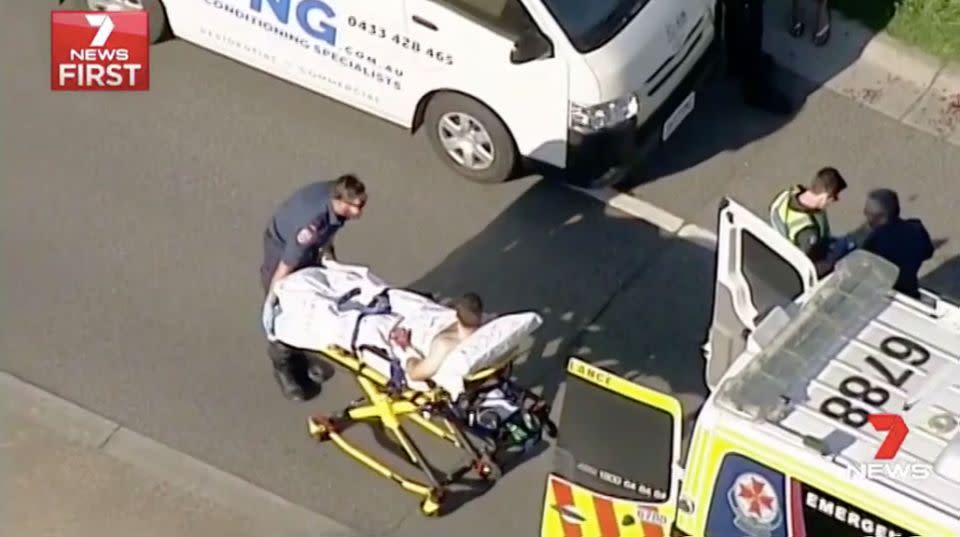 Mr Walsh is stretchered into an ambulance. Source: 7 News