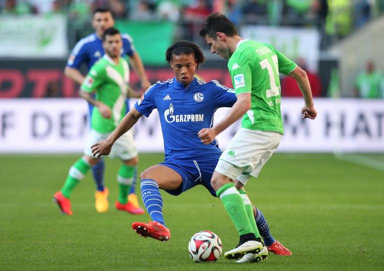 Schalke's striker Leroy Sane (L) vies with Wolfsburg's midfielder Christian Traesch during the German first division Bundesliga football match in Wolfsburg on April 19, 2015