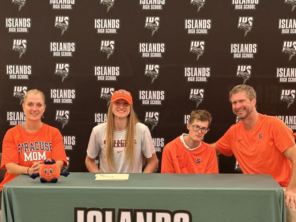 Veronica Sierzant of Islands, with her family, as she signed to play volleyball at Syracuse Thursday.