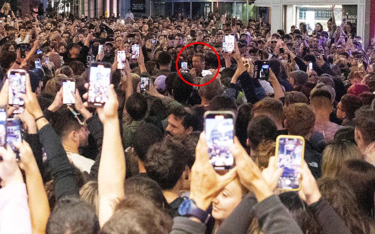 Chris Martin surrounded by fans wielding mobile phones in Dublin