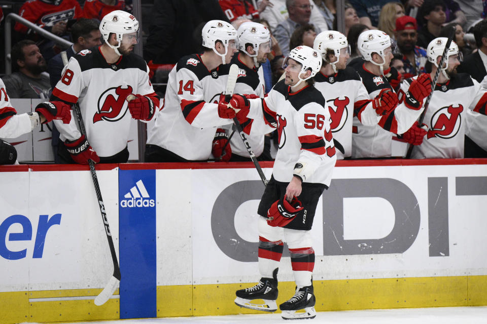 New Jersey Devils left wing Erik Haula (56) is congratulated for his goal against the Washington Capitals during the first period of an NHL hockey game Thursday, April 13, 2023, in Washington. (AP Photo/Nick Wass)