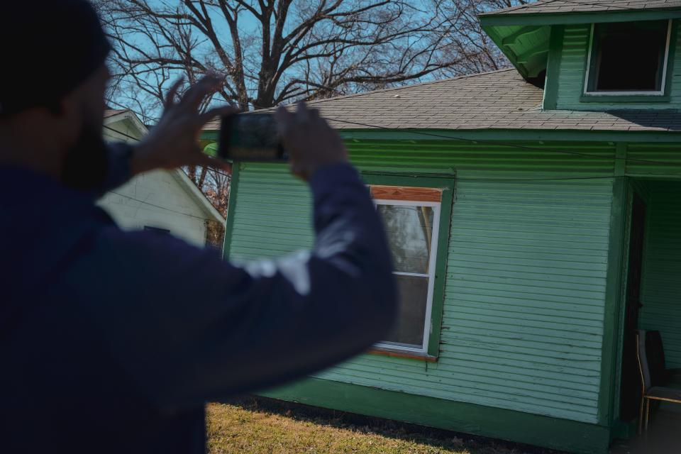 MEMPHIS, TN - January 13, 2024: Randall Marshall takes a photo of a Mallory Heights home while canvassing with Black Millennials for Flint to help people learn about testing their homes for lead.