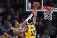 Milwaukee Bucks' Giannis Antetokounmpo (34) puts up a shot against Indiana Pacers' Myles Turner (33) during the first half of an NBA basketball game, Friday, Jan. 27, 2023, in Indianapolis. (AP Photo/Darron Cummings)